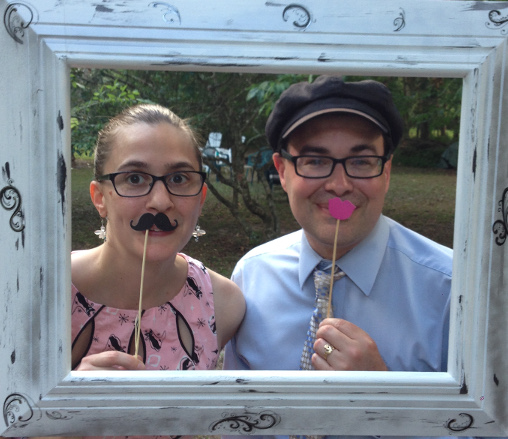 Christy with mustache and Toby with pink lips in a painted frame