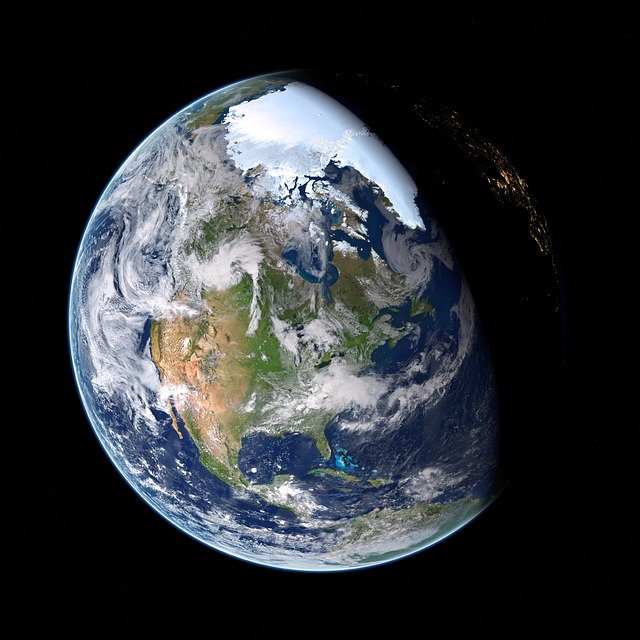 Photo of Earth from space, with part of the planet in daylight, and part in nighttime